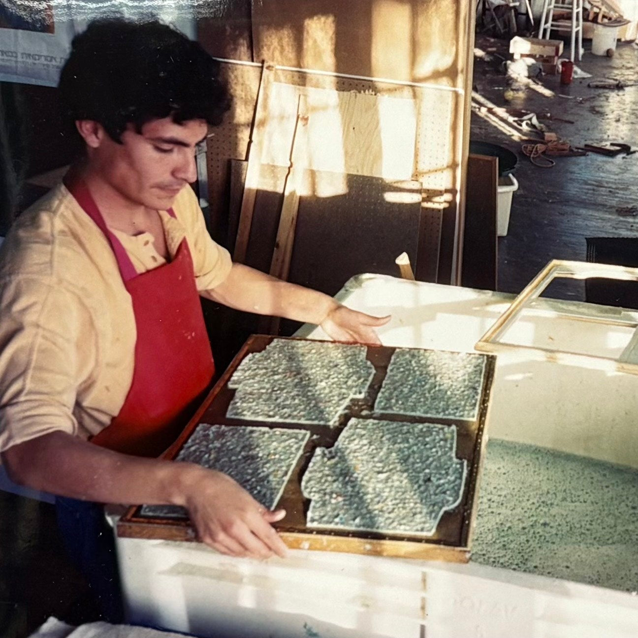 Person working with wood molds in a workshop setting